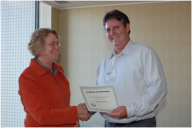 First Vice President Debra Mallette, left, presents Frederick Trevor with a Certificate of Achievement.  Trevor, who earned the third highest CISA exam score in December 2009, was one of many members and attendees who were recognized for their efforts to the chapter and certification and exam accomplishments.
